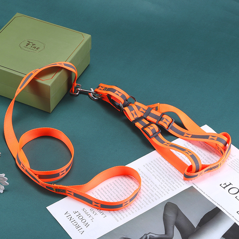 Orange reflective harness leash set on a green tabletop