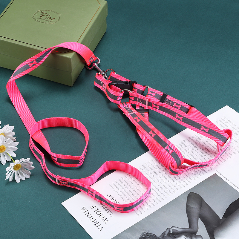 Pink reflective harness leash set arranged on a green tabletop